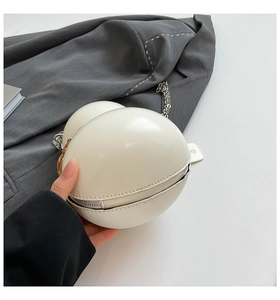 Macro shot of off-white gourd shaped leather crossbody bag with silver chain strap