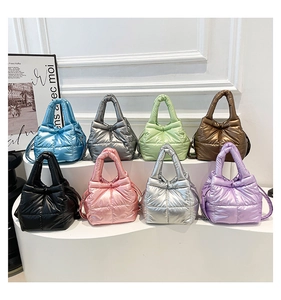 Detail of eight metallic puffer bags in assorted colors with quilted waterproof texture