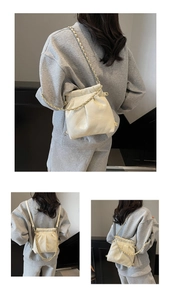 Detail showing white quilted leather texture and gold chain on the convertible mini bag