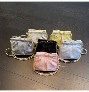 Detailed collection of quilted chain shoulder bags in various colors on wood floor