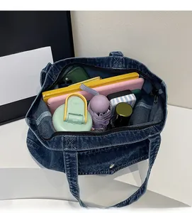 Macro shot showing large storage capacity of blue denim tote bag for daily essentials