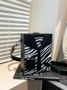Creative tuxedo style box crossbody bag with zebra pattern and wide black strap