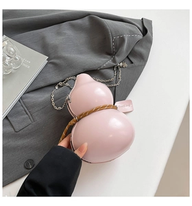 Detailed view of pink glossy gourd-shaped bag with braided rope and metal chain