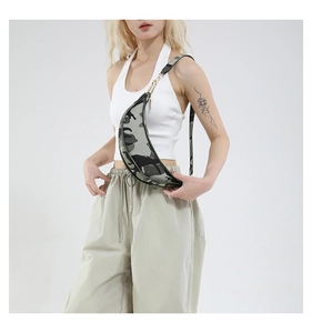 Detail shot of camouflage crescent crossbody bag with metal zipper and adjustable strap
