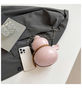 Close-up of pink gourd-shaped shoulder bag with braided rope and silver chain strap
