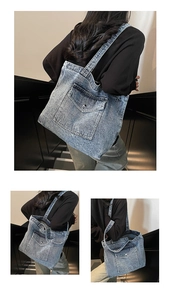 Detailed macro view of retro washed blue denim tote bag with front pocket and silver buckle