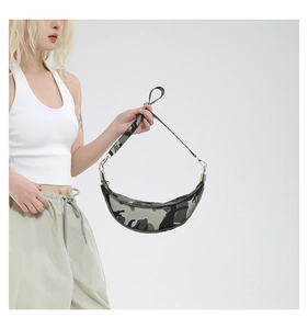 Detail of green camouflage crescent bag with gold metal hooks and adjustable strap