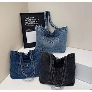 Detailed close-up showing three vintage denim tote bags in light blue, blue and dark grey