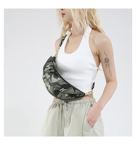 Detail view of crescent camo crossbody bag with golden hardware and canvas texture