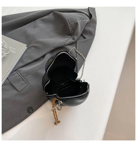 Black heart-shaped crossbody bag with silver chain strap and brown woven rope detail