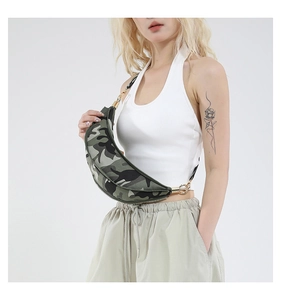 Detail of trendy camouflage crescent bag featuring stylish golden hardware and wide strap