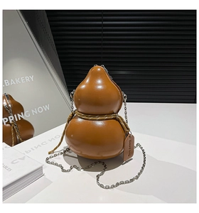 Close-up of brown gourd-shaped leather crossbody bag with chain strap and tag