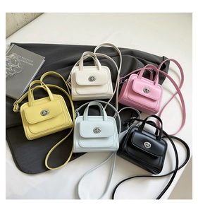 Detailed macro view of minimalist structured handbags in five pastel colors with silver locks
