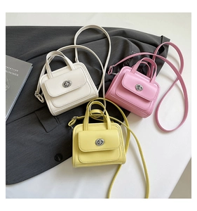 Three structured mini handbags in cream, pink, and yellow with silver twist locks