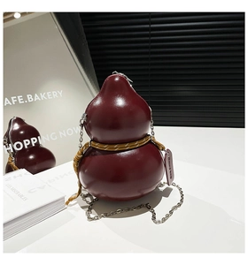 Detail of burgundy gourd-shaped leather crossbody bag with chain strap and tag