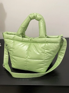 Quilted light green puffer tote bag with adjustable shoulder strap and glossy nylon finish