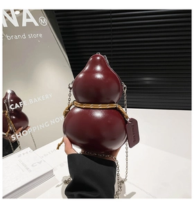 Detail of burgundy gourd-shaped bag with woven rope decor and gold chain strap
