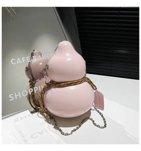 Detailed close-up of a pink gourd-shaped crossbody bag with metal chain and woven rope