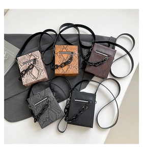 Detailed view of mini square crossbody bags with snakeskin patterns and acrylic chains