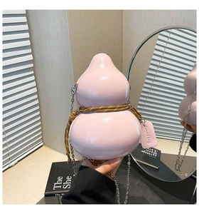 Close-up of pink gourd-shaped bag with woven rope detail and silver chain strap