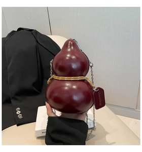 Detail of burgundy gourd-shaped leather crossbody bag with metallic chain and woven rope