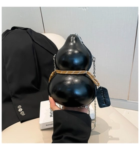 Macro shot of black gourd-shaped bag featuring woven rope detail and silver chain strap