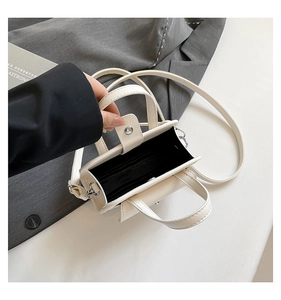 Detail view of mini white tote bag showing interior card slots and magnetic closure