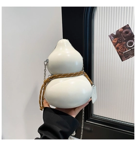 Detailed macro view of the white gourd-shaped crossbody bag with woven rope and chain
