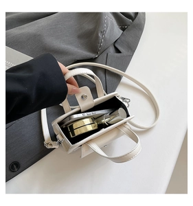 Interior view showing the capacity for a smartphone, powder, and lipstick in the cream bag