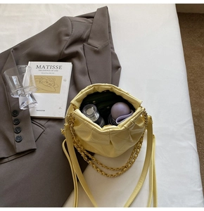 Top view of quilted leather bucket bag showing interior storage and gold chain strap