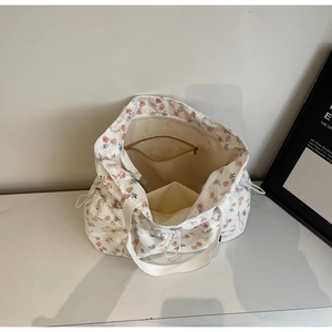 Internal view showing the spacious storage with a zipper pocket in this floral tote bag