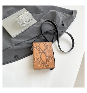 Detailed top view of structured small square crossbody bag with brown snake skin texture