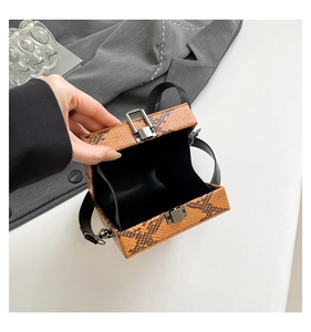 Top view of snake print crossbody bag open interior with silver metal lock detail