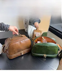 Macro detail of large PU leather travel makeup bag with double layer zippers and top handle