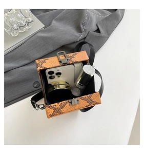 Interior view of orange snakeskin textured crossbody bag showing storage for daily essentials