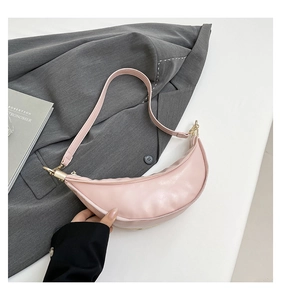 Close-up of light pink hobo bag with soft PU leather texture and gold metal buckle