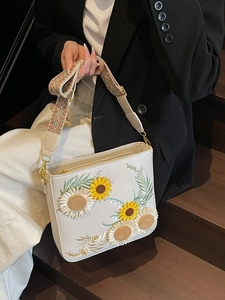 Chic white crossbody bag with sunflower embroidery and a wide ethnic jacquard strap