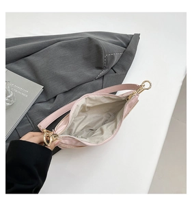 Close-up of pink nylon dumpling bag showing grey lining and golden zipper details
