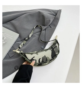 Detail of camouflage crescent crossbody bag with golden metal buckle and zipper closure