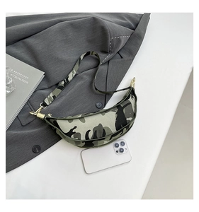 Detailed view of camo crescent bag with gold hardware and phone size reference