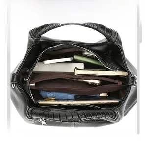 Top view of spacious black tote bag showing organized daily essentials and woven handles
