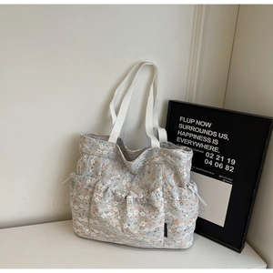 Detailed macro view of the lace floral tote bag featuring functional side drawstring pockets