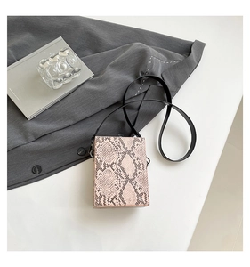 Detailed top view of a minimalist faux snake skin crossbody bag with a slim black strap