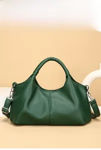 Close-up of dark green lychee grain leather handbag with silver hardware and top handle
