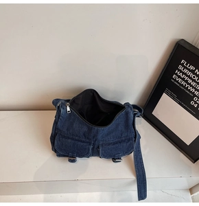 Detailed top view of retro denim shoulder bag with multi-pockets and metal buckles