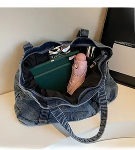 Spacious interior of vintage denim tote bag showing tablet, umbrella and daily essentials