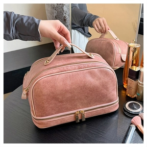 Detailed view of pink double-layer PU leather toiletry bag with zipper and handle