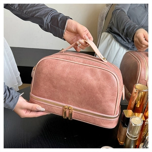 Detail of pink retro leather makeup bag showing dual-layer storage and gold zipper hardware
