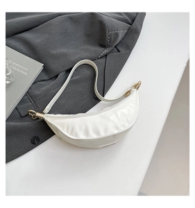 Close-up of a white crescent moon bag with smooth PU leather and gold metal zipper