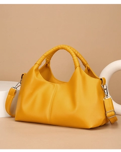 Detail of ginger yellow lychee grain leather tote with unique wrapped handle design